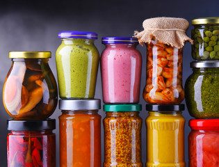 Jars with variety of pickled vegetables and fruits