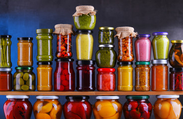 Jars with variety of pickled vegetables and fruits
