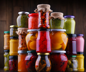 Jars with variety of pickled vegetables and fruits