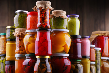 Jars with variety of pickled vegetables and fruits