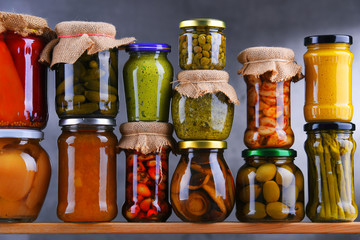 Jars with variety of pickled vegetables and fruits