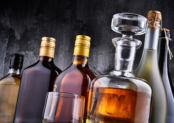 Carafe and bottles of assorted alcoholic beverages.