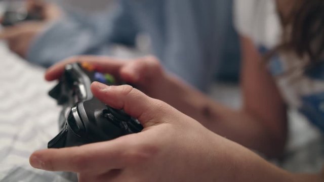 Girl hand holding game joystick. Gamer press buttons on gamepad