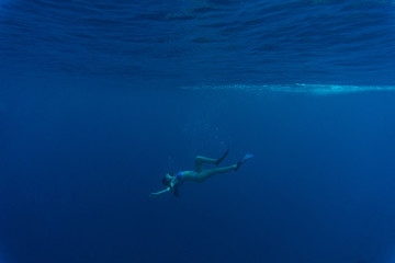 Young woman dive in blue underwater. Girl dive, underwater scene.
