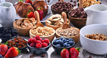 Different sorts of breakfast cereal products and fresh fruits