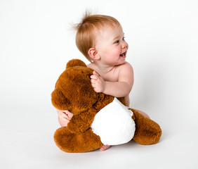 Baby hugging her teddy bear
