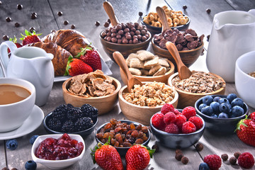 Different sorts of breakfast cereal products and fresh fruits