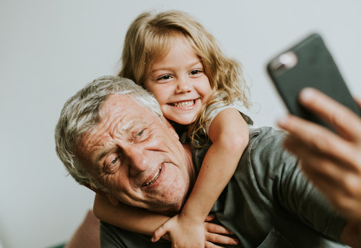 Grandfather taking a selfie with his granddaughter