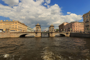 Fototapeta premium SAINT-PETERSBURG, RUSSIA, June 29, 2017, Pleasure boat floats on the rivers and channels in a historical central Saint Petersburg on a sunny day
