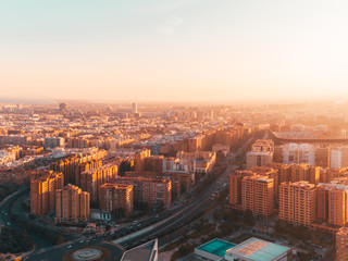 Plakat Scenic futuristic city skyline of modern downtown in beautiful orange sunset sunrise golden hour time. Urban cityscape view of streets in megapolis. Real estate concept