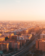 Scenic futuristic city skyline of modern downtown in beautiful orange sunset sunrise golden hour time. Urban cityscape view of streets in megapolis. Real estate concept