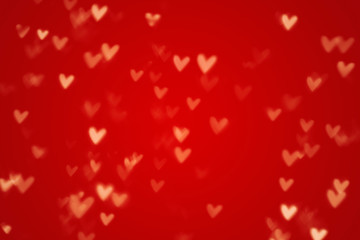 Valentine heart bokeh lights against a red background