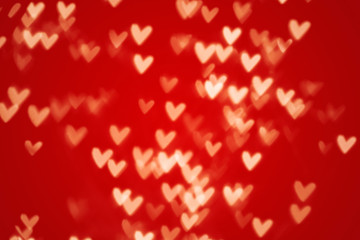 Valentine heart bokeh lights against a red background