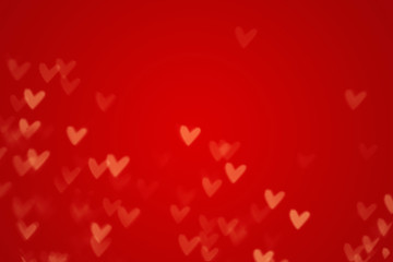 Valentine heart bokeh lights against a red background