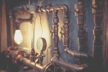 Plumbing pipes against a gray wall in style loft