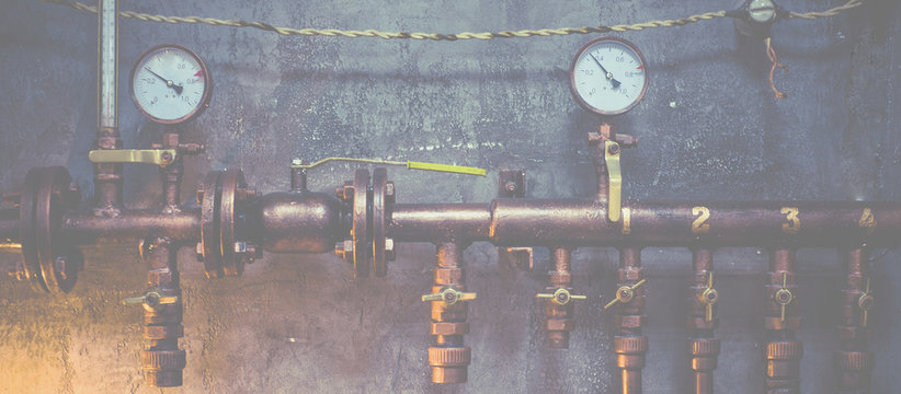 Plumbing pipes against a gray wall in style loft