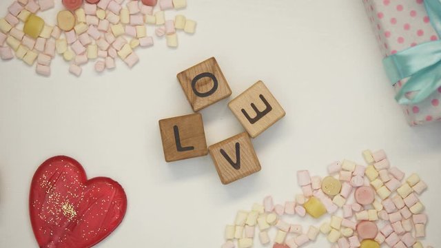 Love word on wooden cubes, family traditions and values, romantic relationship
