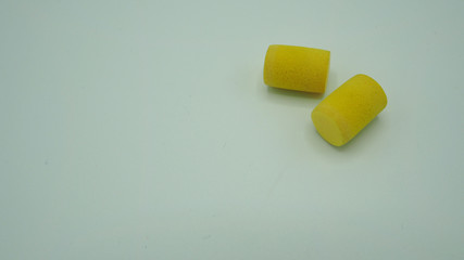 Ear plugs on white background.It is yellow color.