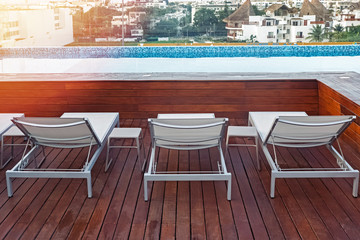 Sunbeds near swimming pool in the modern building