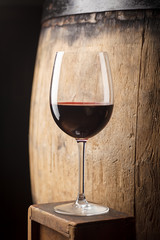 Red wine near a barrel