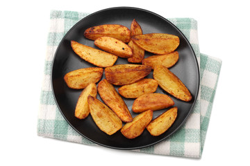 Fried potato wedges on black plate isolated on white background. top view. Fast food.