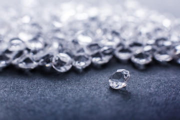 a scattering of artificial diamonds with bokeh on the background close-up