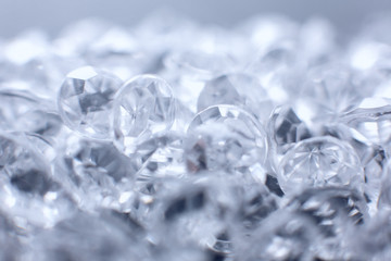 a scattering of artificial diamonds with bokeh on the background close-up