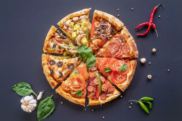 Different slices of pizza laid out in the shape of a round pizza . Margarita, Hawaiian, vegetarian,...