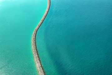 Aerial view of a dam in the water near the coast of Dubai