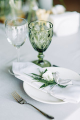 Decor wedding table in the cafe. Floristry and glass glasses at the wedding.