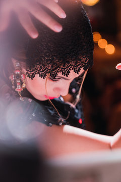 Woman in dress with upped hand dancing on scene