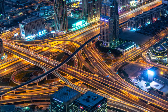 Aerial view of a highway road interchange in Dubai at night, United Arab Emirates