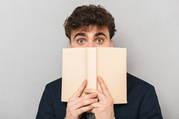 Surprised young businessman wearing suit standing