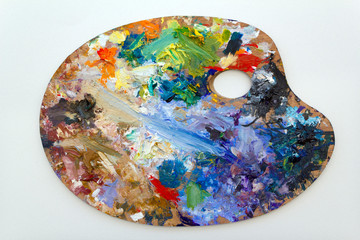 Obraz na płótnie Canvas Vibrant multi-coloured artists oil or acrylic paints palette on textured white paper