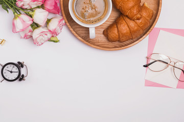 Creative composition with coffe, flowers and croissants