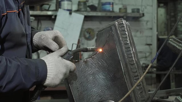 Blacksmith Holding Welding Machine For Welding Details