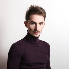 Obraz premium Handsome young elegant man in violet golf.