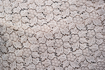 Soft folds of a white genuine traditional lace placemat to be used as background