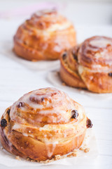Cinnamon rolls buns on a white marble wooden background. Bakery concept. Breakfast and brunch. Flatlay. Minimalistic photo. Overhead. Copy space
