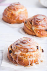 Cinnamon rolls buns on a white marble wooden background. Bakery concept. Breakfast and brunch. Flatlay. Minimalistic photo. Overhead. Copy space