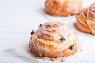 Cinnamon rolls buns on a white marble wooden background. Bakery concept. Breakfast and brunch. Flatlay. Minimalistic photo. Overhead. Copy space