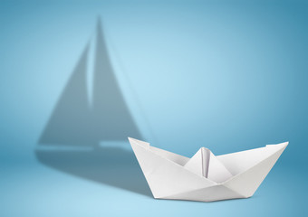 Sailing yacht concept, paper ship with sailing boat shadow