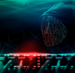 Anonymous computer hacker with hood behind cables