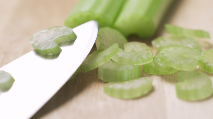 Housewife cutting celery to cook in the kitchen.