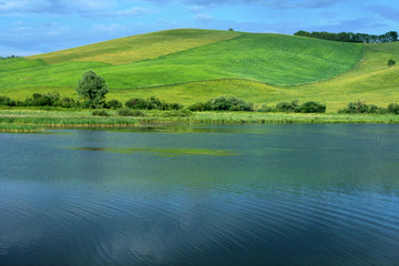 Beautiful green hill and blue lake water