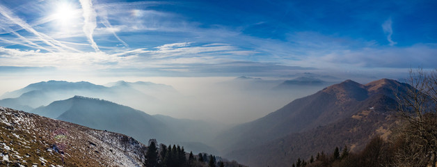 Panoramic view on Lombardy Prealps in foggy winter day
