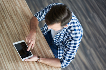 Close-up  man  using digital tablet at home
