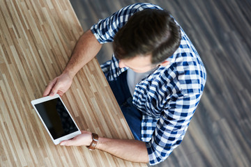 Close-up of  man  using tablet at home