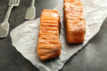 Pieces of tasty grilled salmon on table