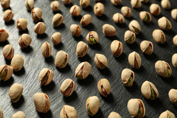 Tasty pistachio nuts on slate plate